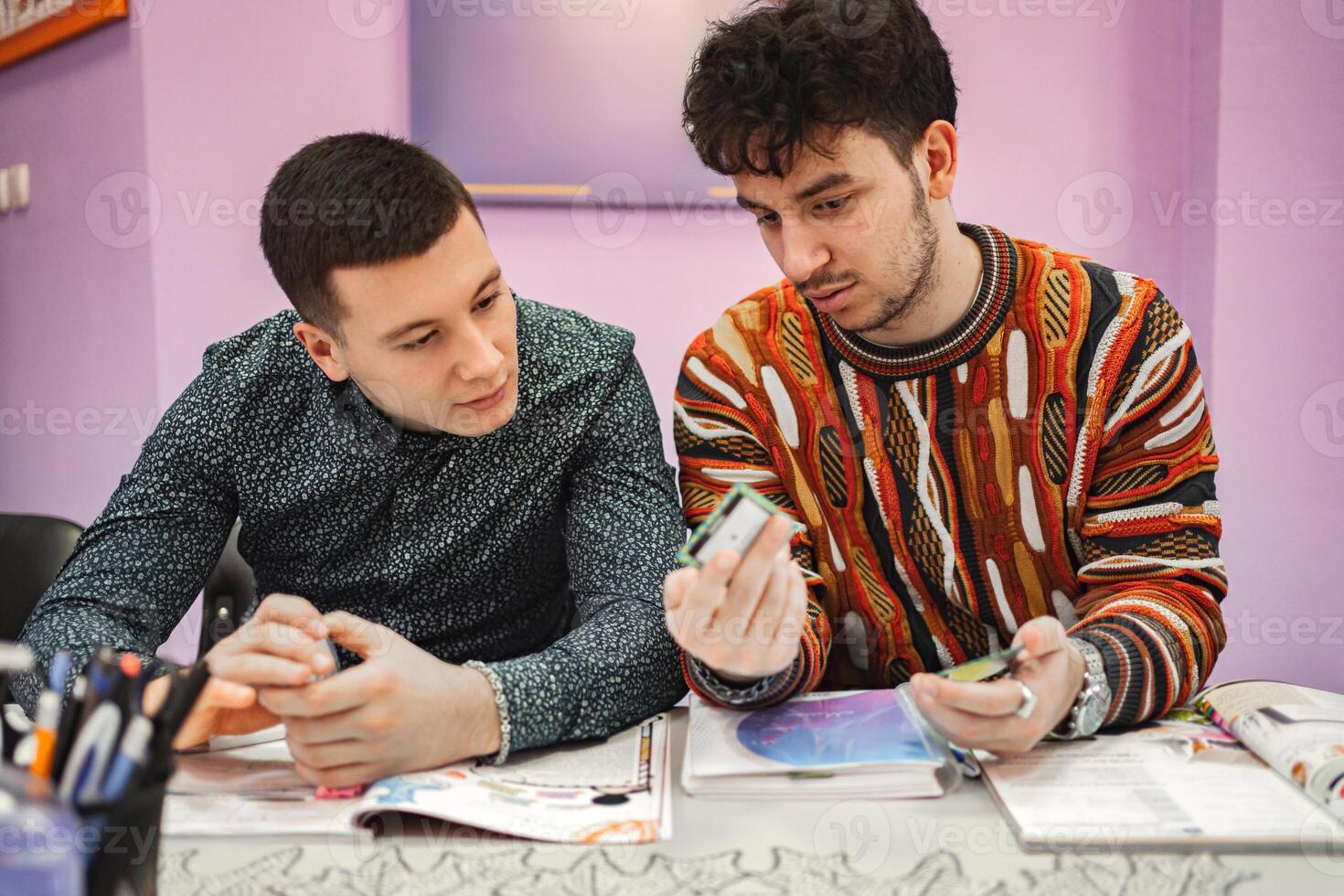 Two male students learning together at language school photo