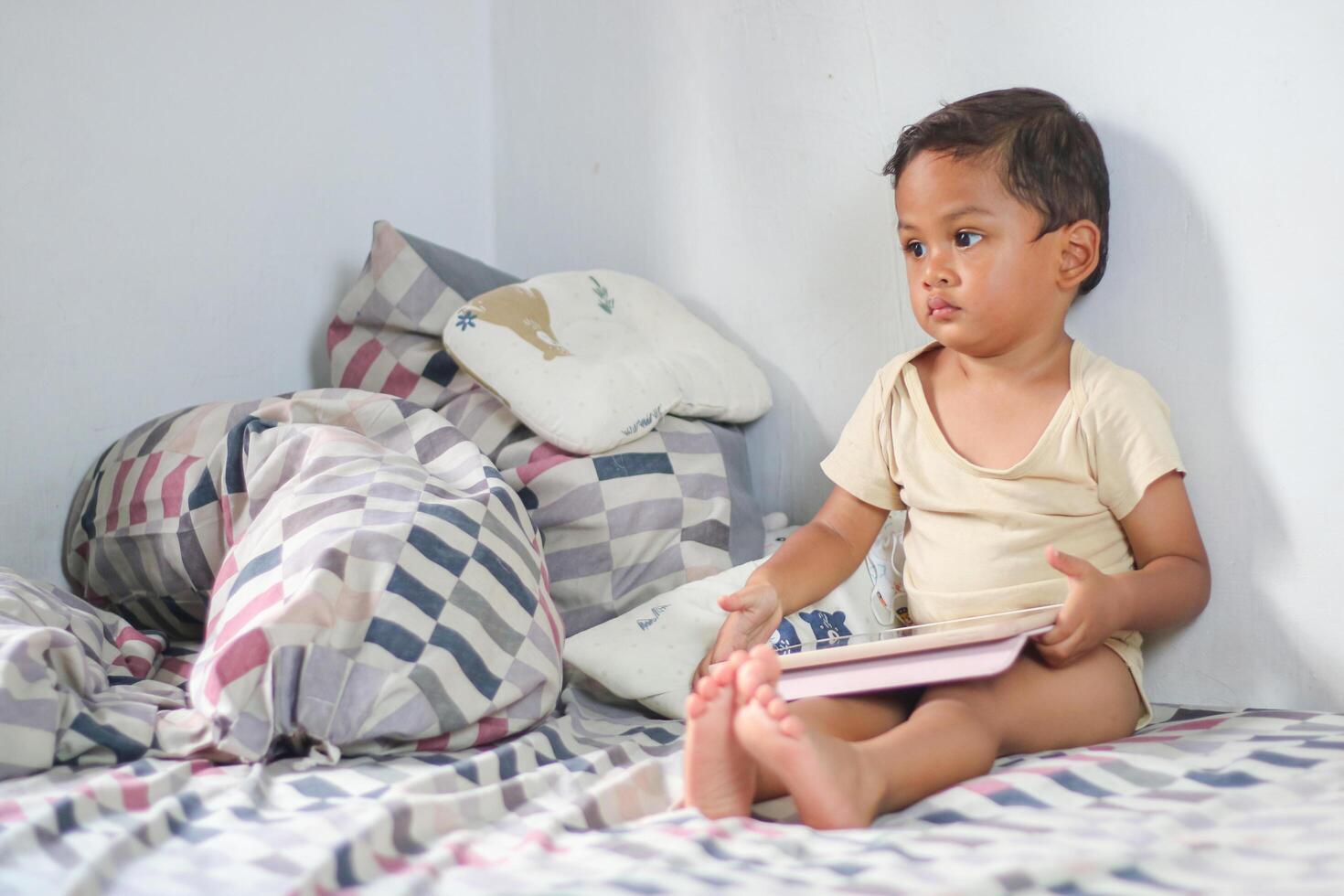 Kids with tablet computer. Child with pc watching movie or playing game. Boy with digital device and gadget. Screen time and education for young kid. photo