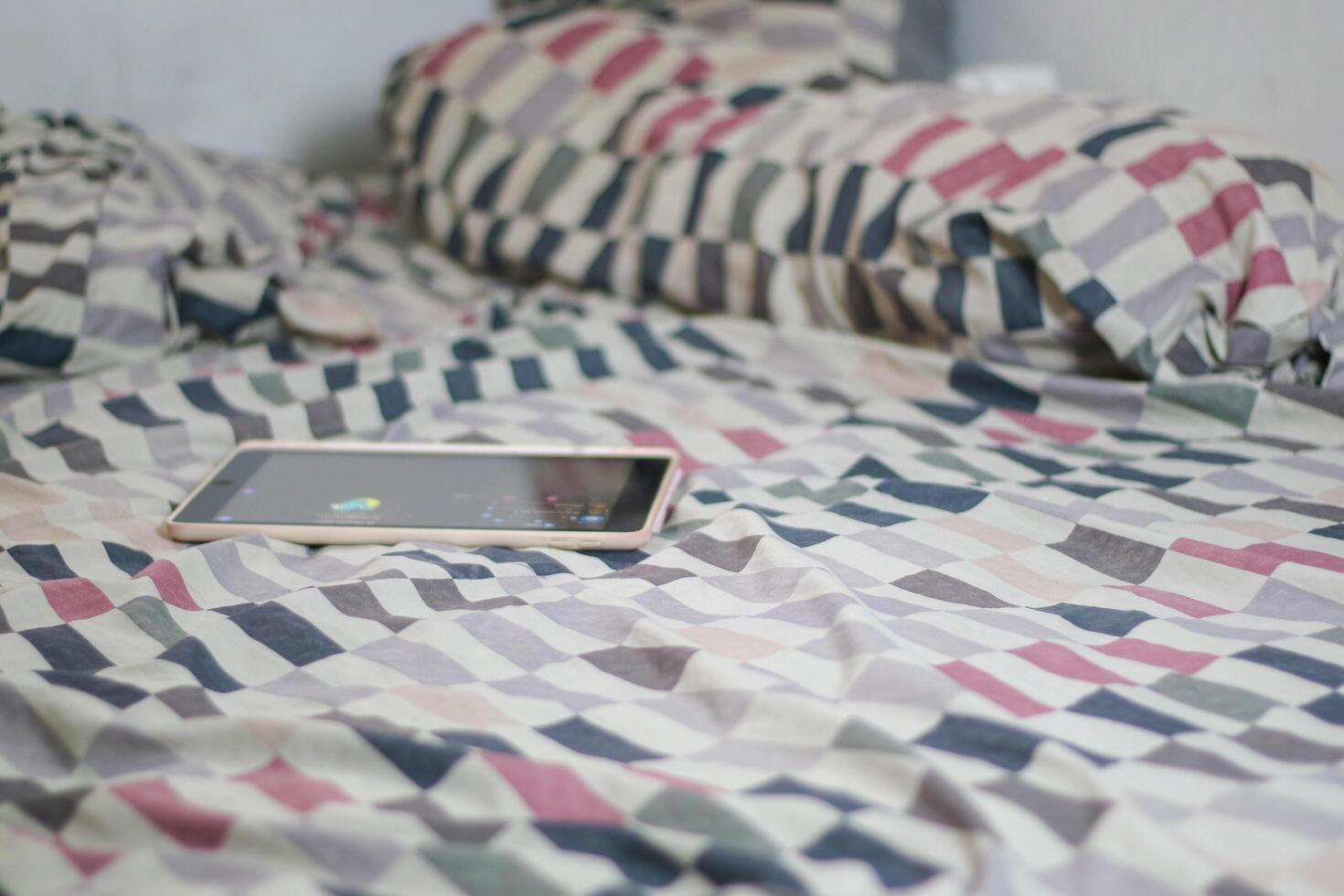 Tablet is on the mattress after being used by the child. photo