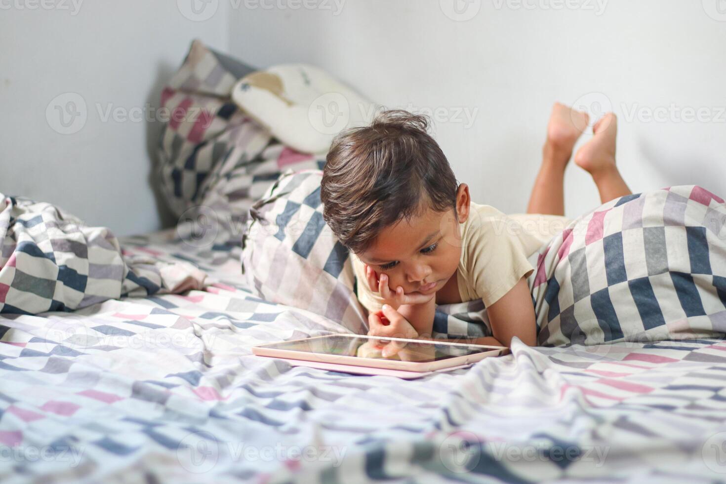 Kids with tablet computer. Child with pc watching movie or playing game. Boy with digital device and gadget. Screen time and education for young kid. photo