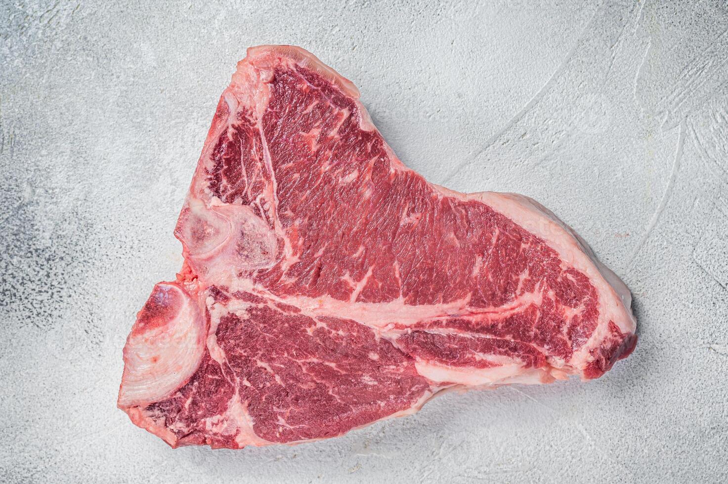 Porterhouse T-bone raw beef meat Steak. White background. Top view photo