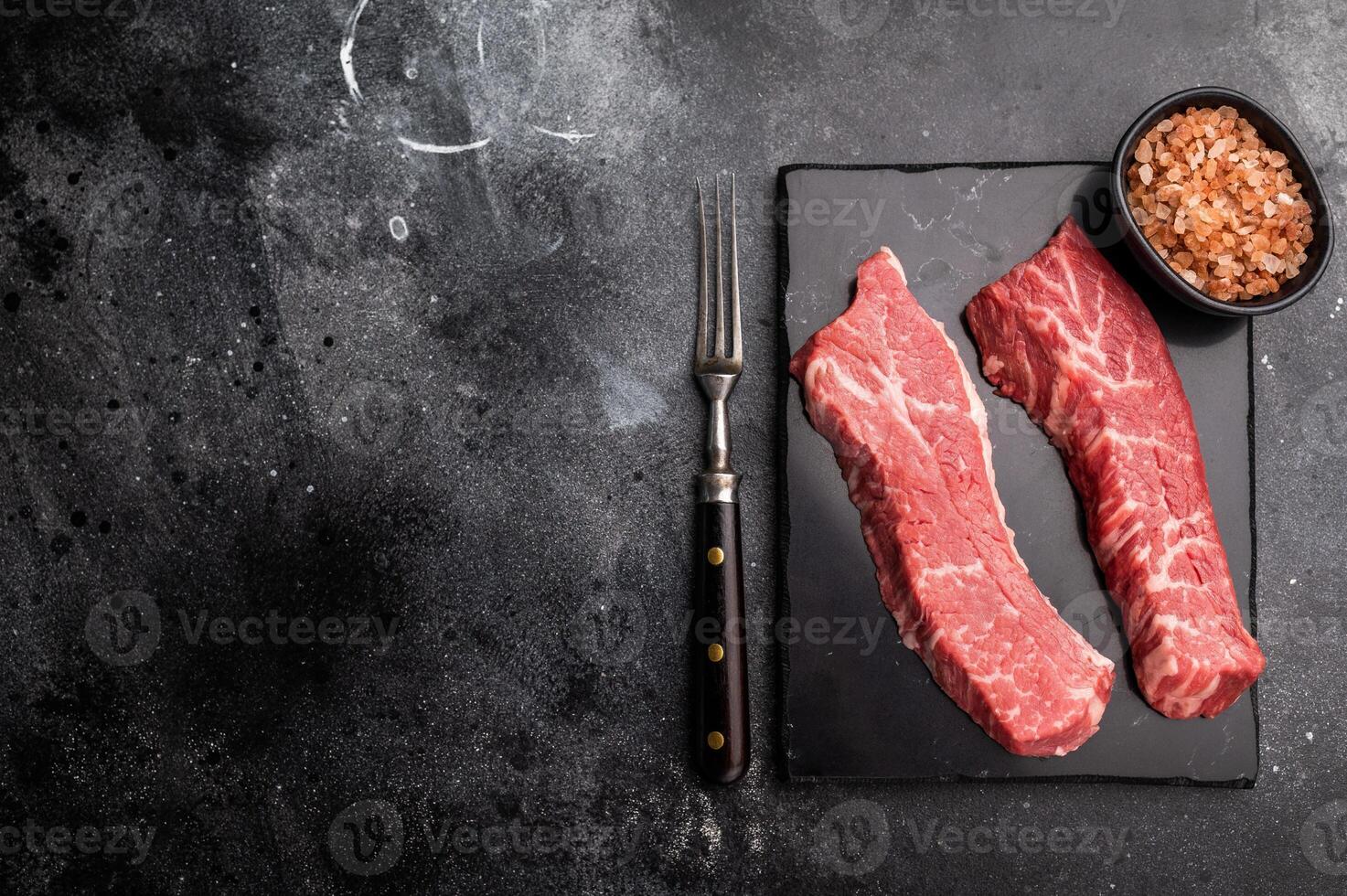 Raw Tri Tip Steak from Black Angus beef meat . black background. top view photo