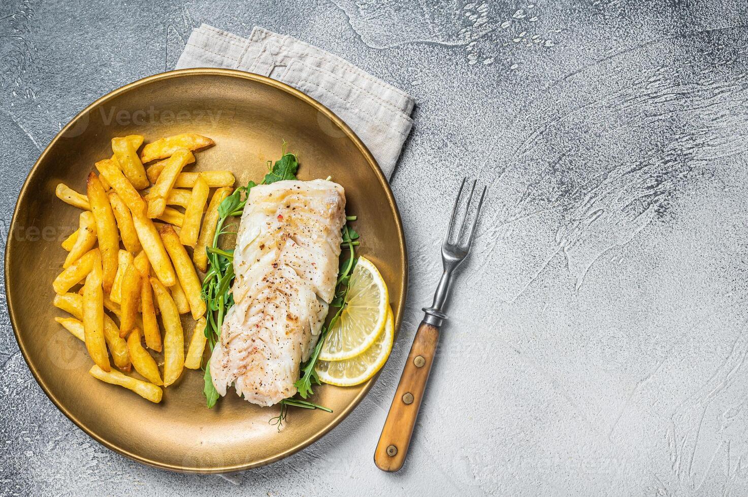 Fried cod fish fillet served with french fries. White background. Top view. Copy space photo