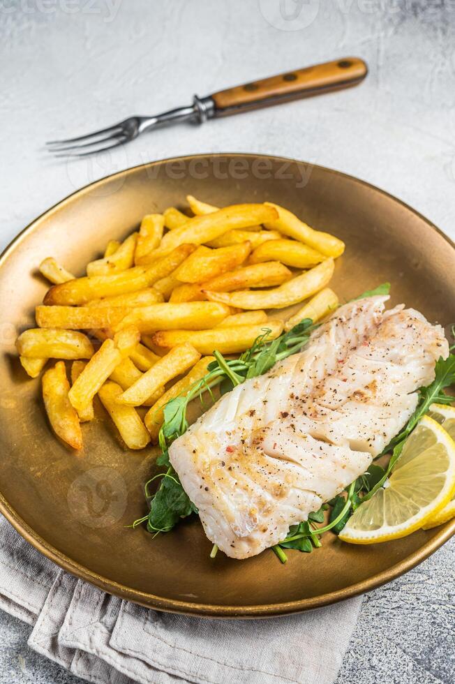 Fried cod fish fillet served with french fries. White background. Top view photo