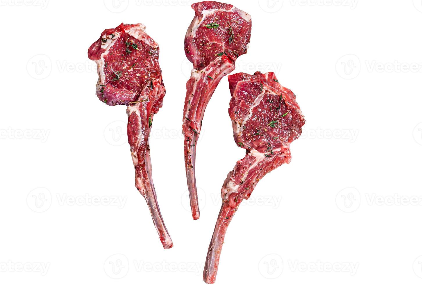 Raw uncooked lamb mutton meat chops steaks on a butcher cleaver. Isolated on white background. photo