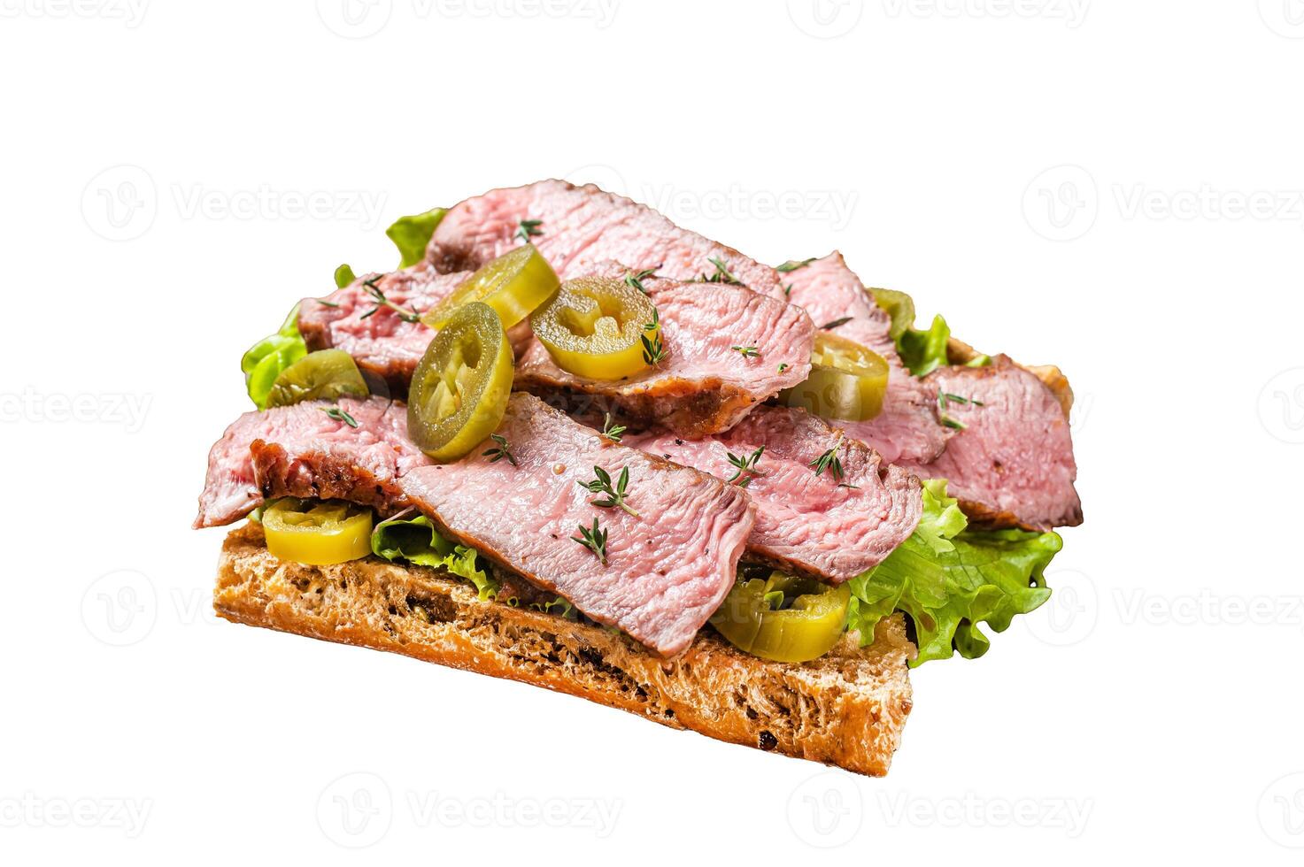 Griiled Steak sandwich with sliced beef, rocket and vegetables on bread. Isolated on white background, top view. photo