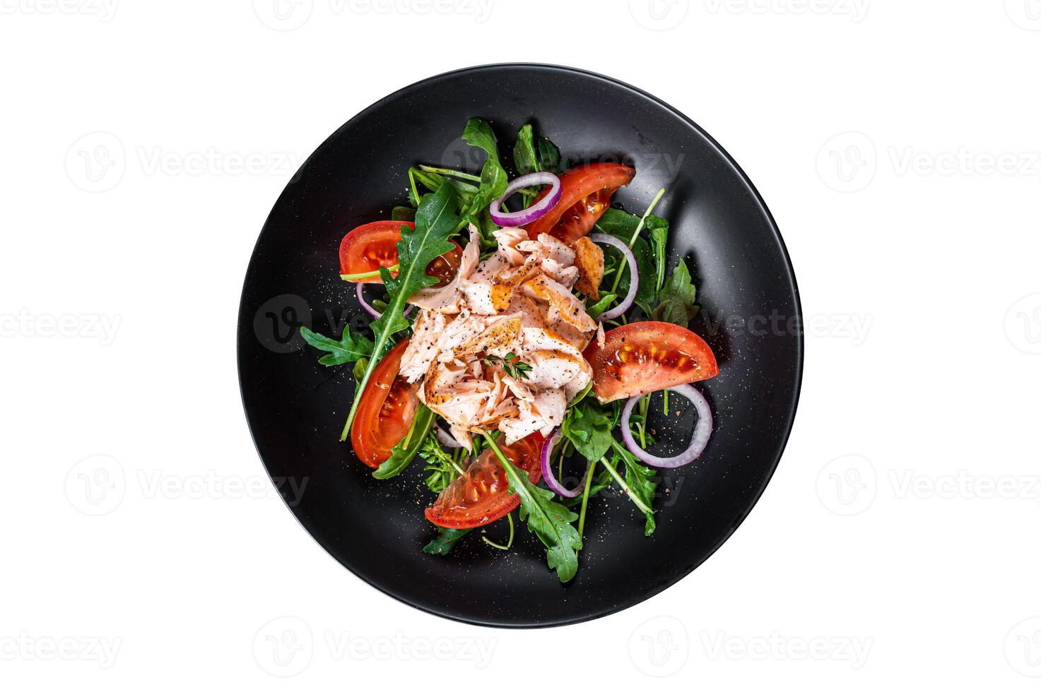 Salad with roasted salmon fillet steak, fresh salad arugula and tomato in a plate. Isolated, white background. Top view. photo