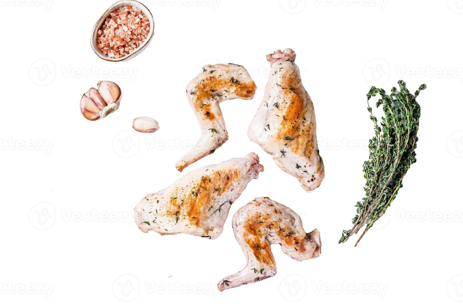 Baked rabbit legs on a grill with thyme. Isolated on white background, top view. photo
