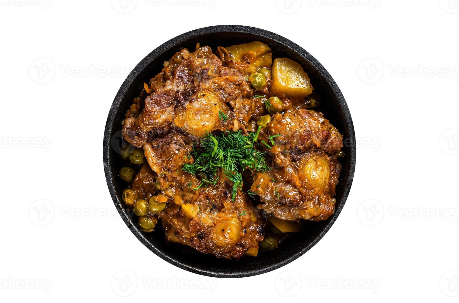 Beef oxtails stew with wine and vegetables in a pan. Isolated, white background. Top view. photo