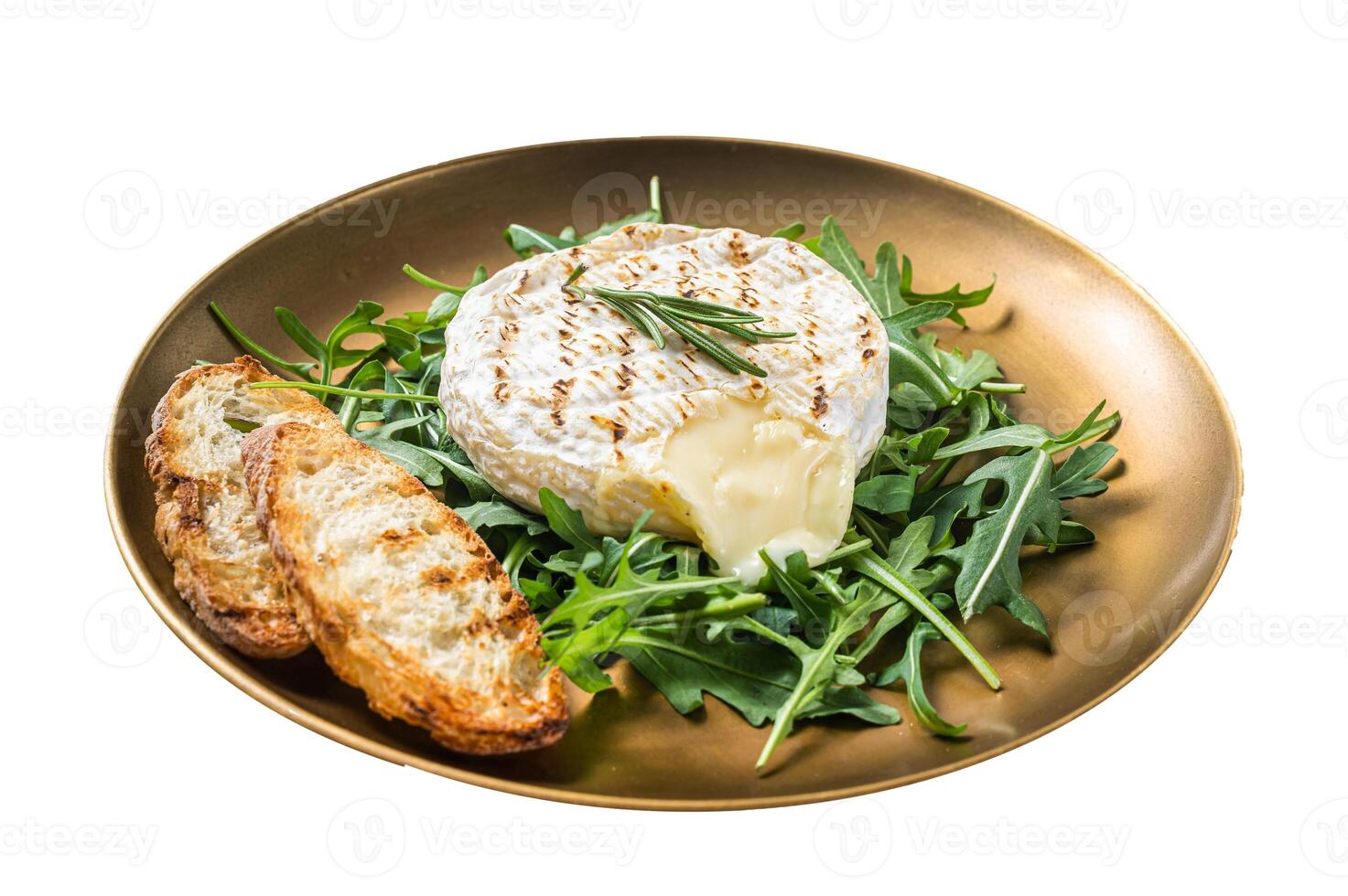 Salad with grilled Camembert cheese, arugula, toast and rosemary in a plate. Isolated on white background. Top view. photo