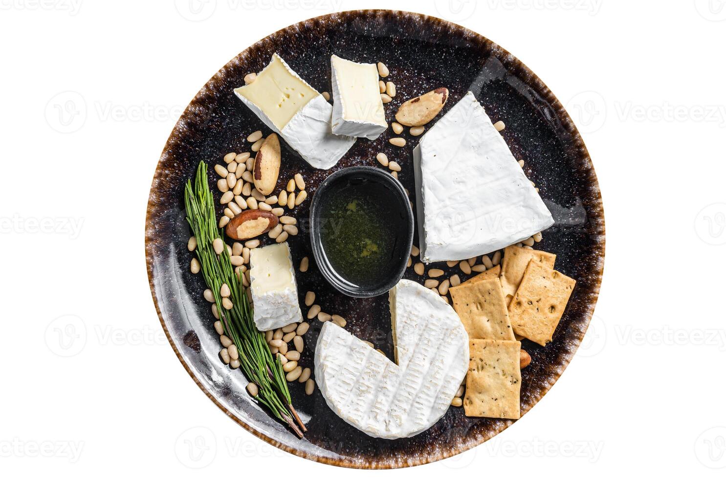 Cheese plate with brie and camembert on rustic plate with nuts and honey. Isolated on white background. photo