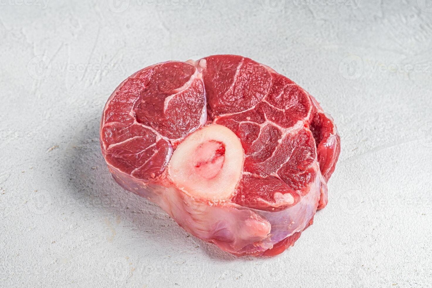 Raw Osso buco Veal shank steak, meat Ossobuco. White background. Top view. Copy space photo