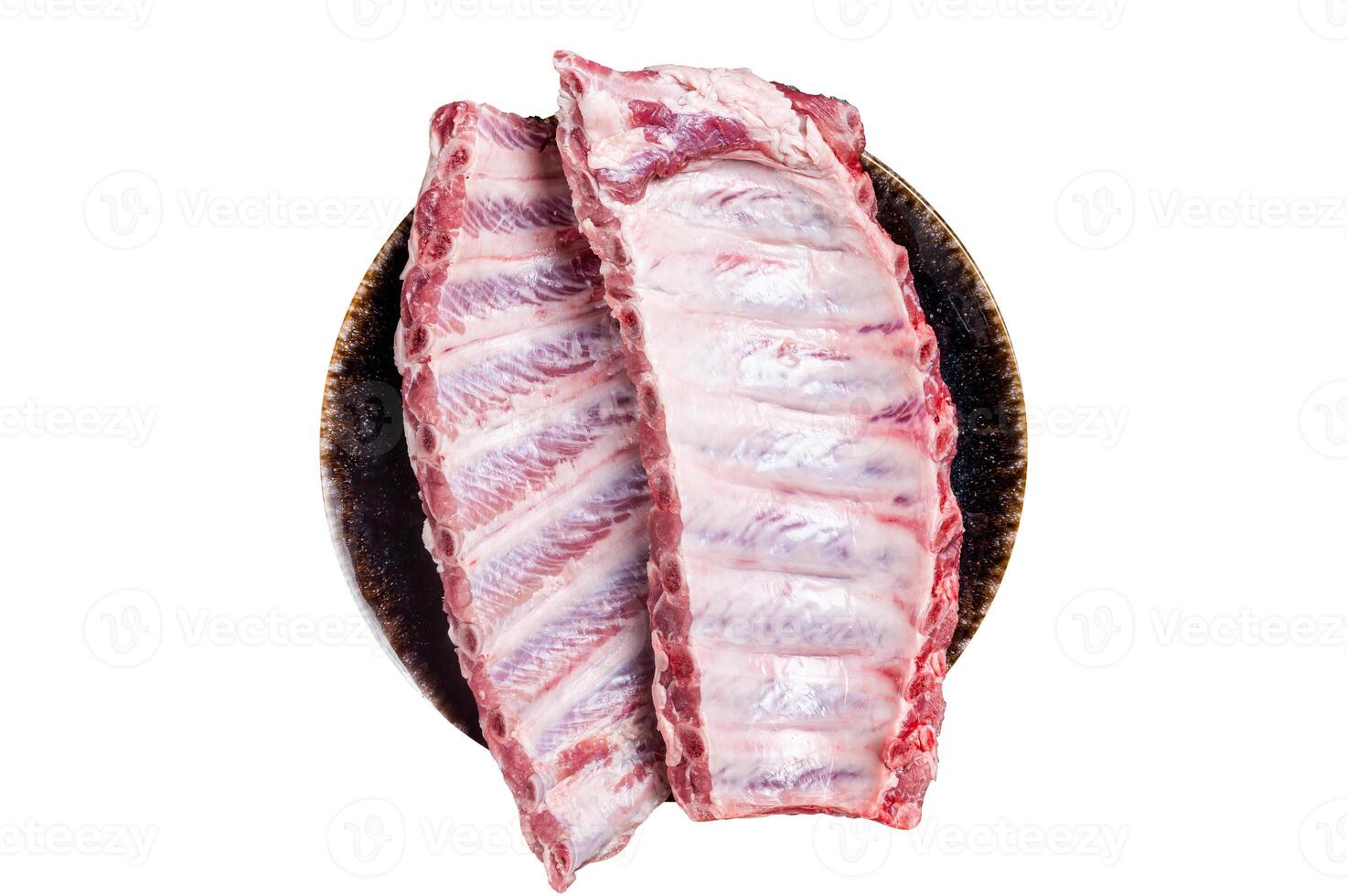 Raw Pork Spareribs, uncooked spare ribs on a plate. Isolated on white background. photo