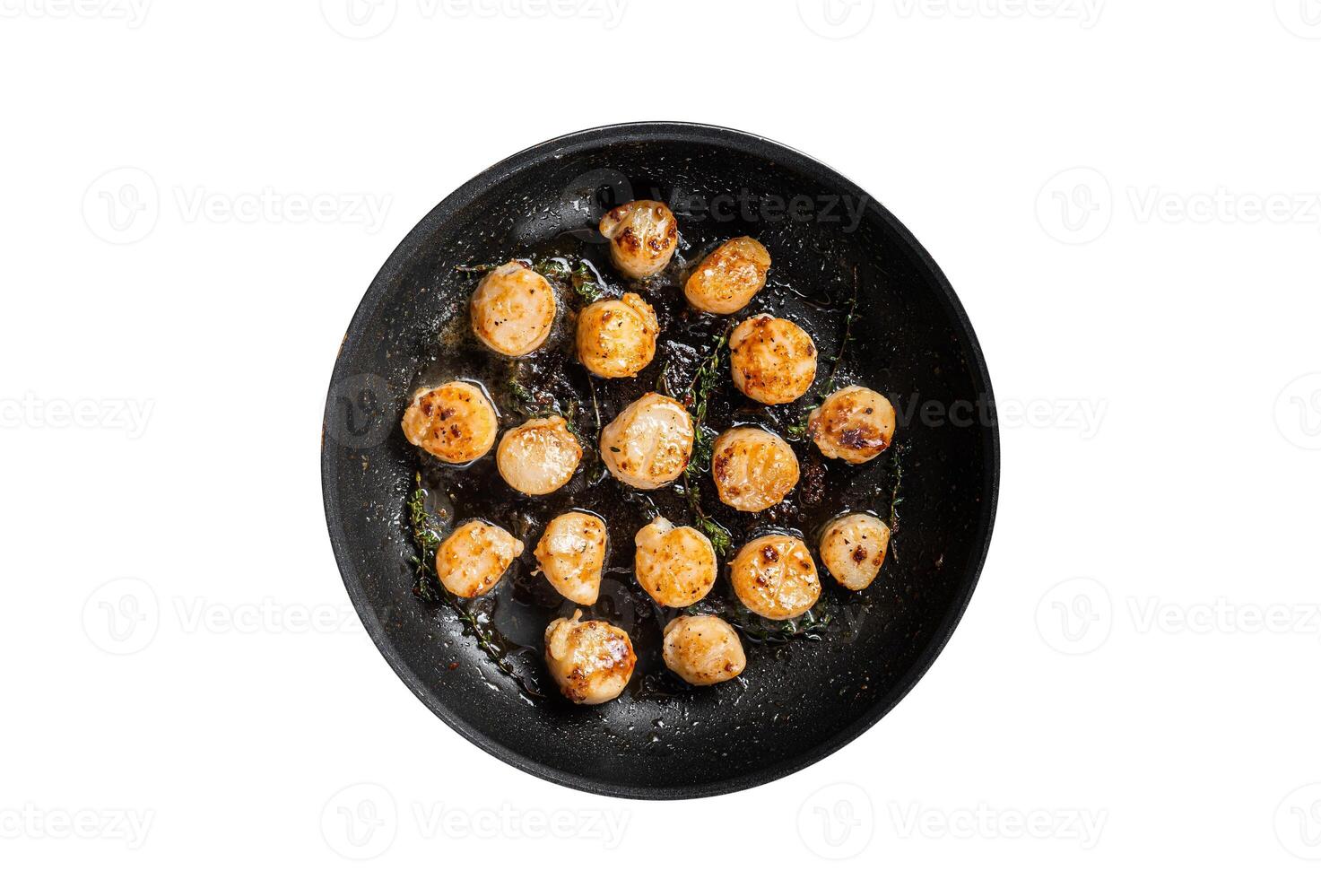 Fried scallops with butter lemon sauce in a skillet. Isolated on white background. photo