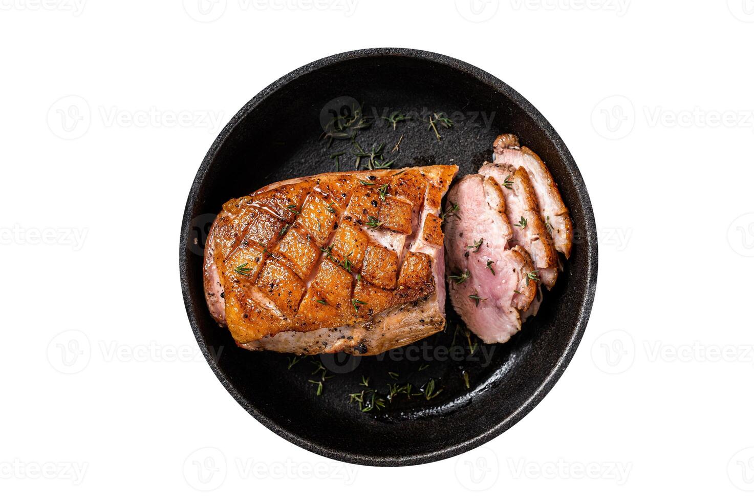 Duck breast roasted in a pan, poultry meat steak with herbs. Isolated, white background. Top view. photo