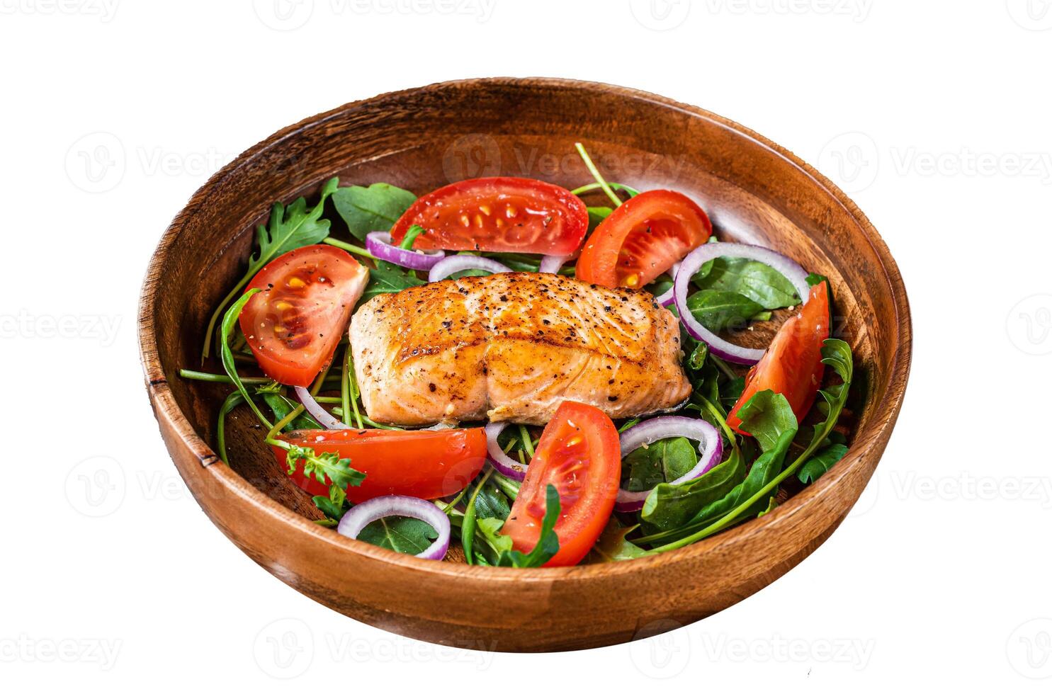 Salmon steak salad with green leaves arugula, avocado and tomato in a wooden plate. Isolated on white background, top view. photo