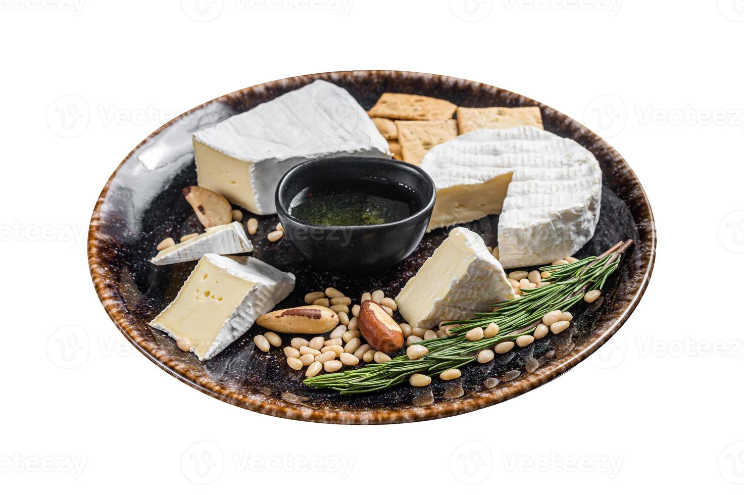 Cheese plate with brie and camembert on rustic plate with nuts and honey. Isolated on white background. Top view. photo