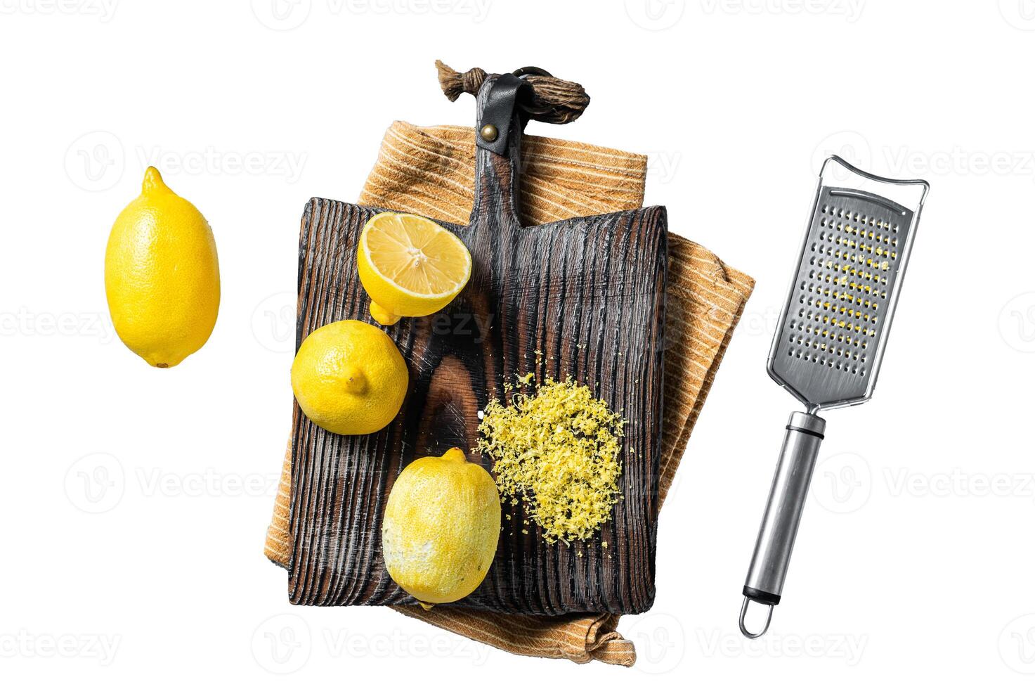 Raw grated Lemon Zest peel on wooden board. Isolated on white background, top view. photo