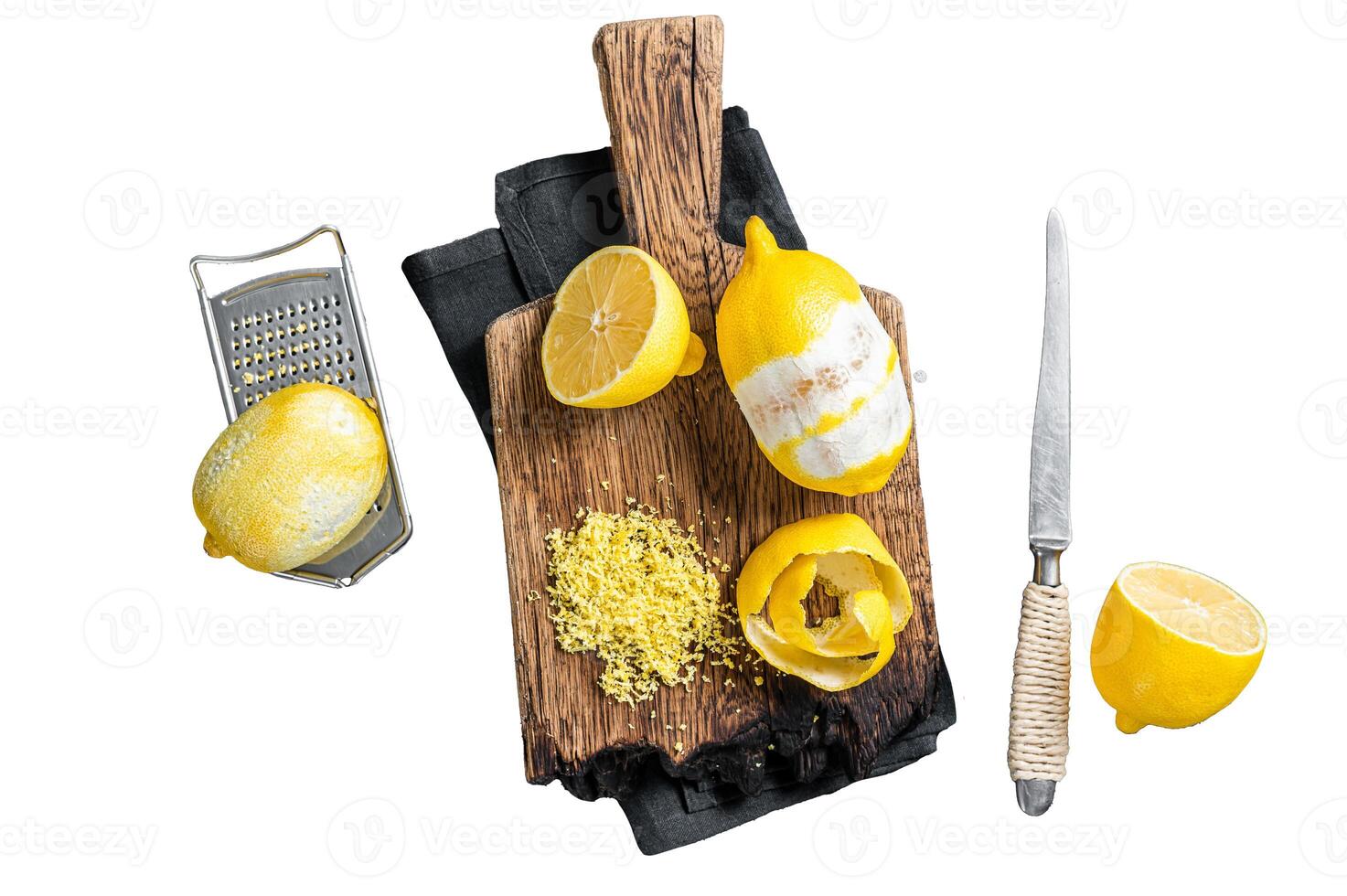 Grated Lemon Zest and spiral peel on wooden board. Isolated on white background, top view. photo