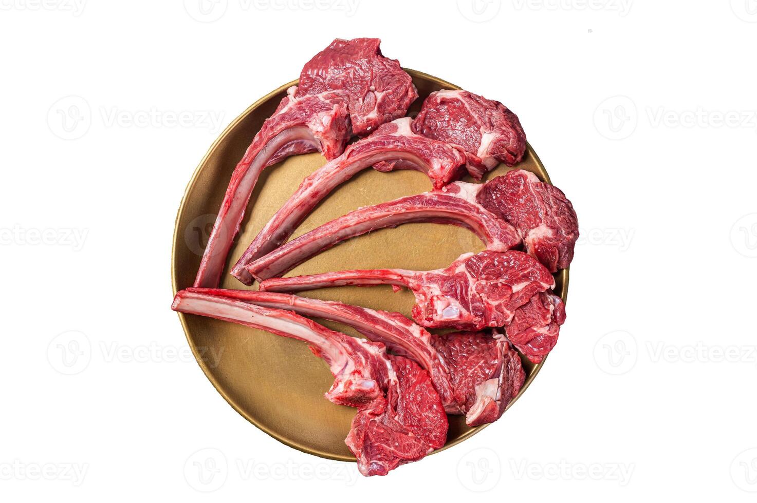 Lamb chop rib steak, raw mutton meat cutlet in golden plate. Isolated on white background photo