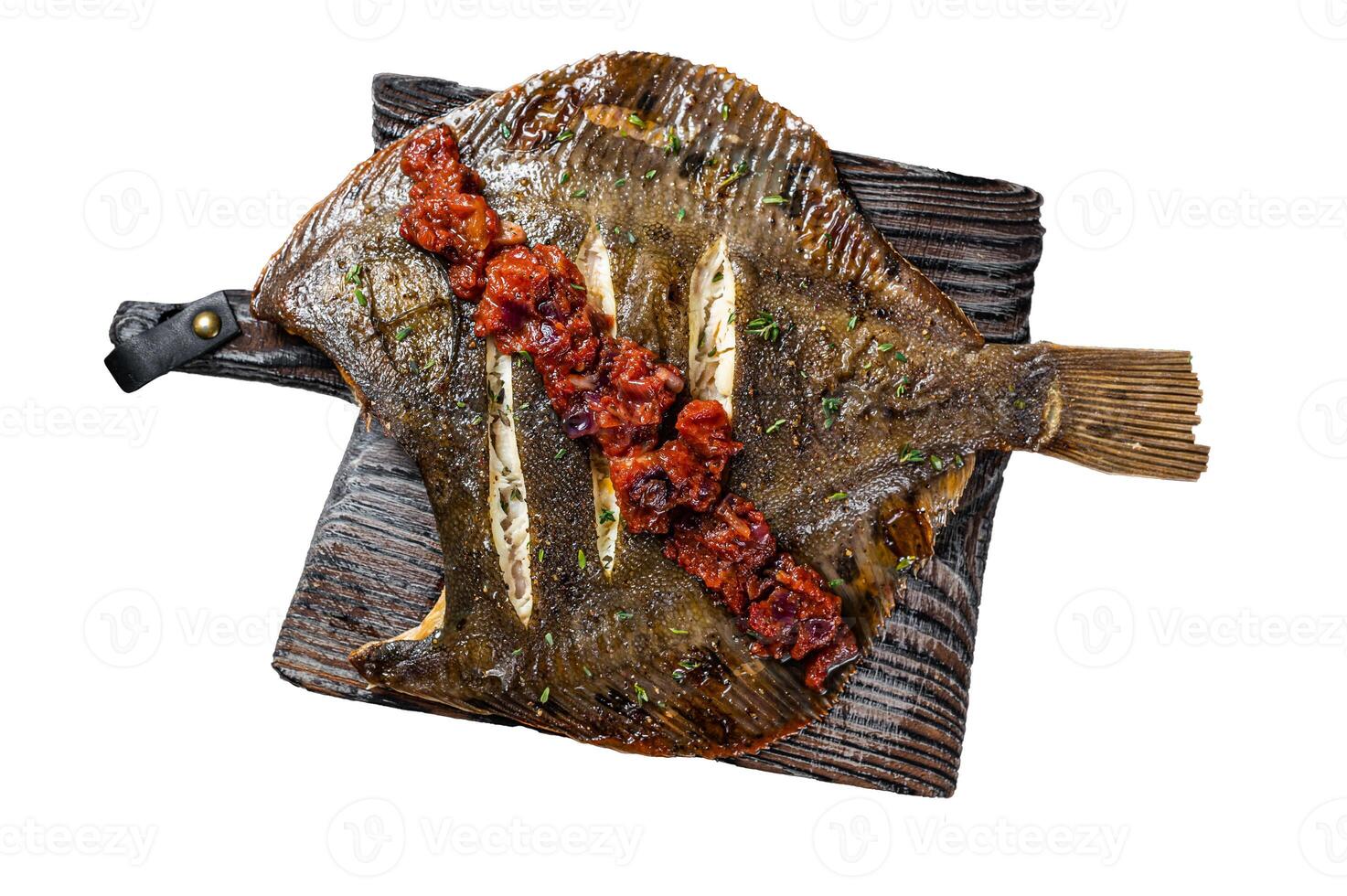 Grilled Flounder or plaice with tomato sauce on wooden cutting board. Isolated on white background. photo