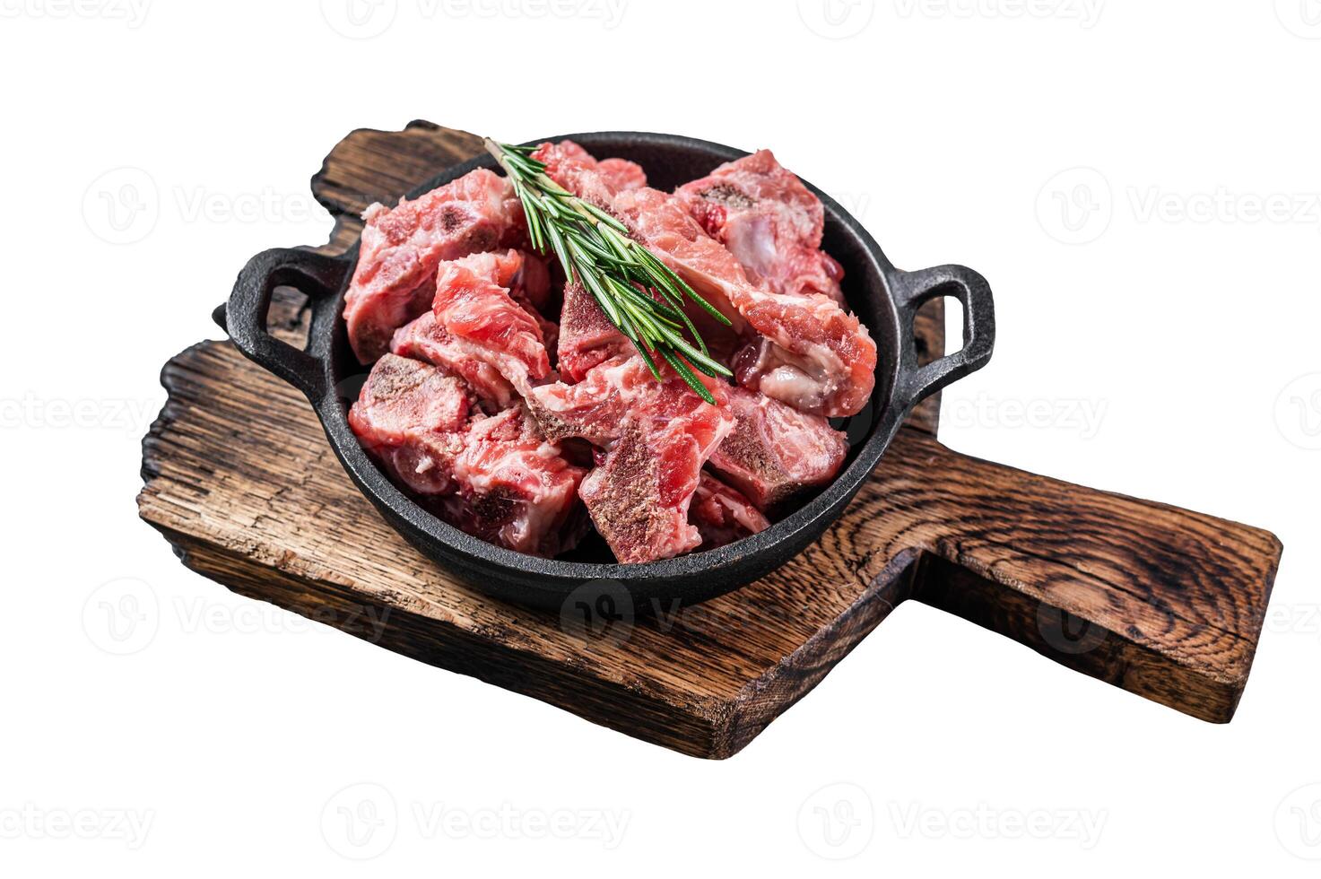 Raw diced meat cubes with bone in a pan. Isolated, white background. photo