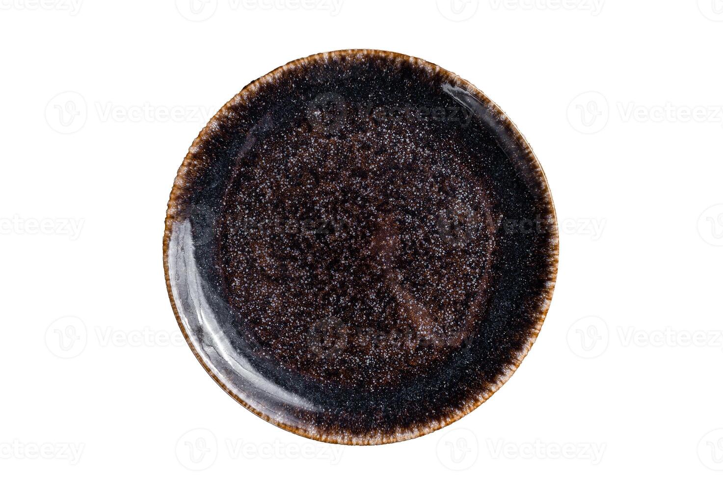 Empty black craft plate on table. Table setting. Isolated on white background photo
