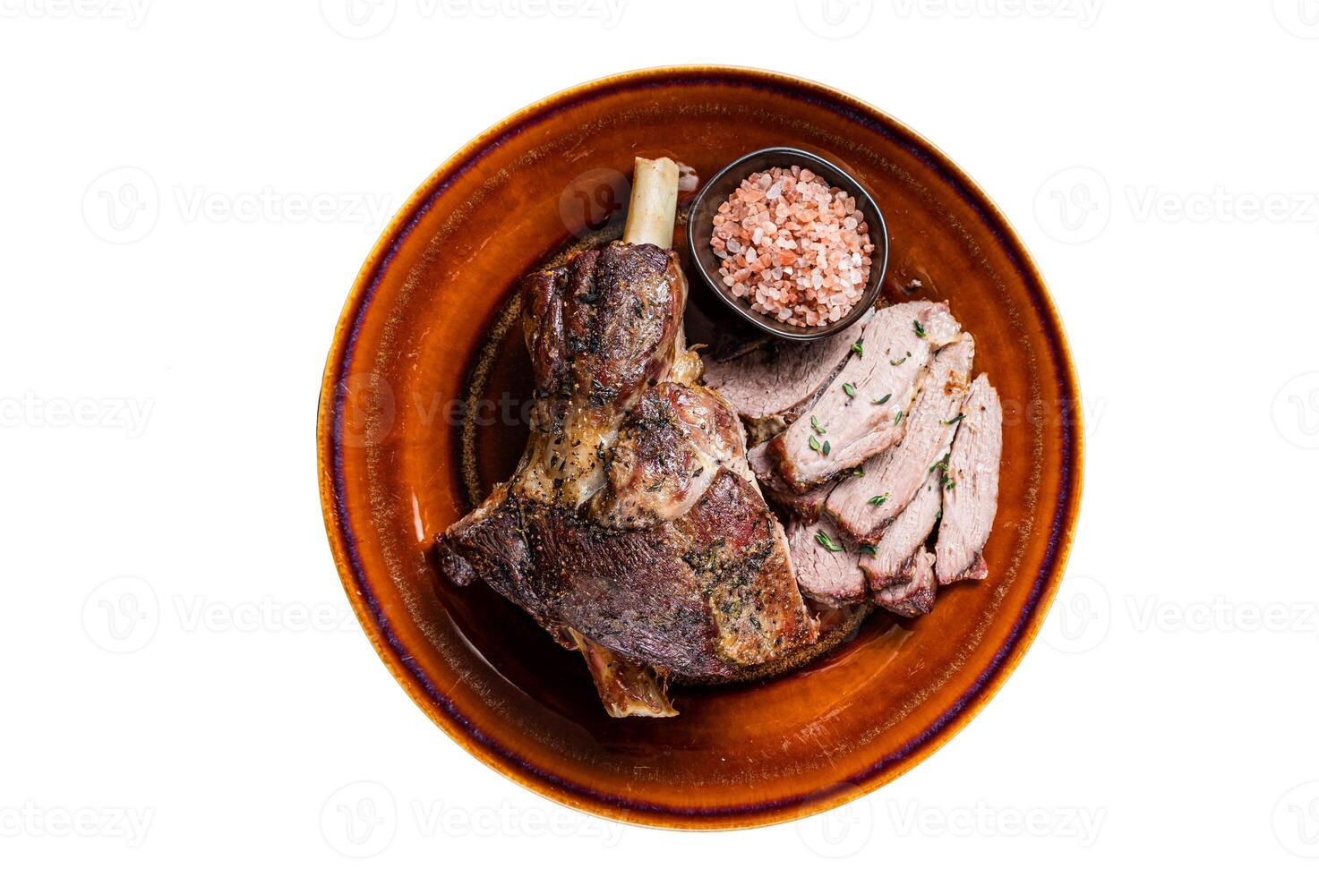 BBQ Roast Lamb mutton leg sliced on a rustic plate. Isolated on white background photo