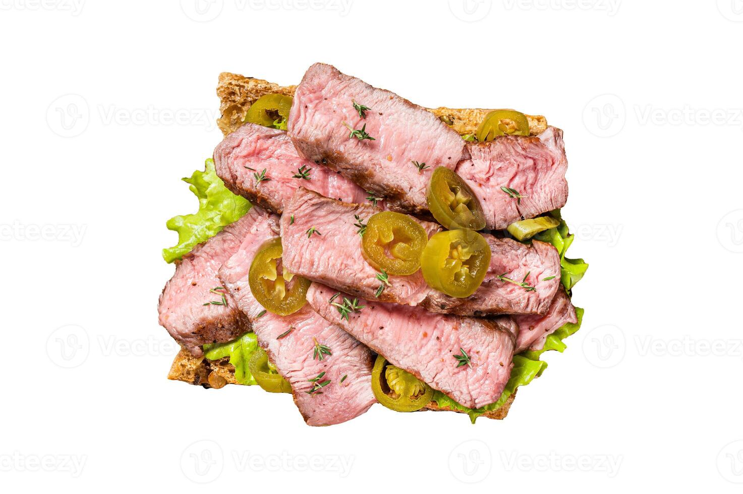 Griiled Steak sandwich with sliced beef, rocket and vegetables on bread. Isolated on white background, top view. photo