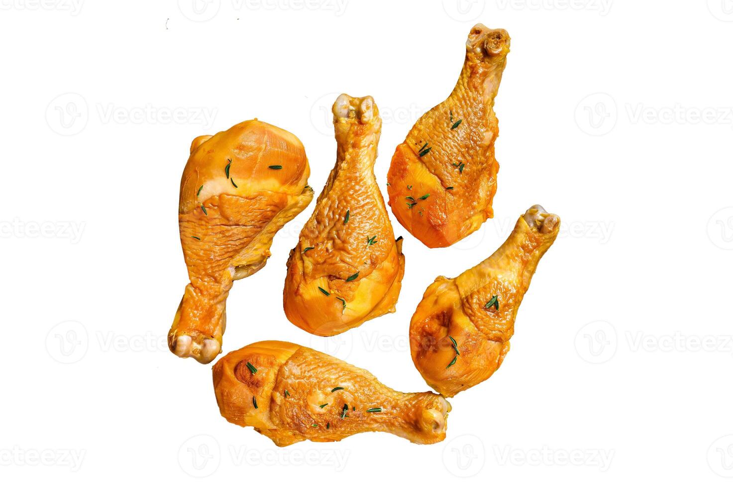Fresh Smoked chicken drumsticks on a rustic plate with herbs. Isolated on white background, top view. photo