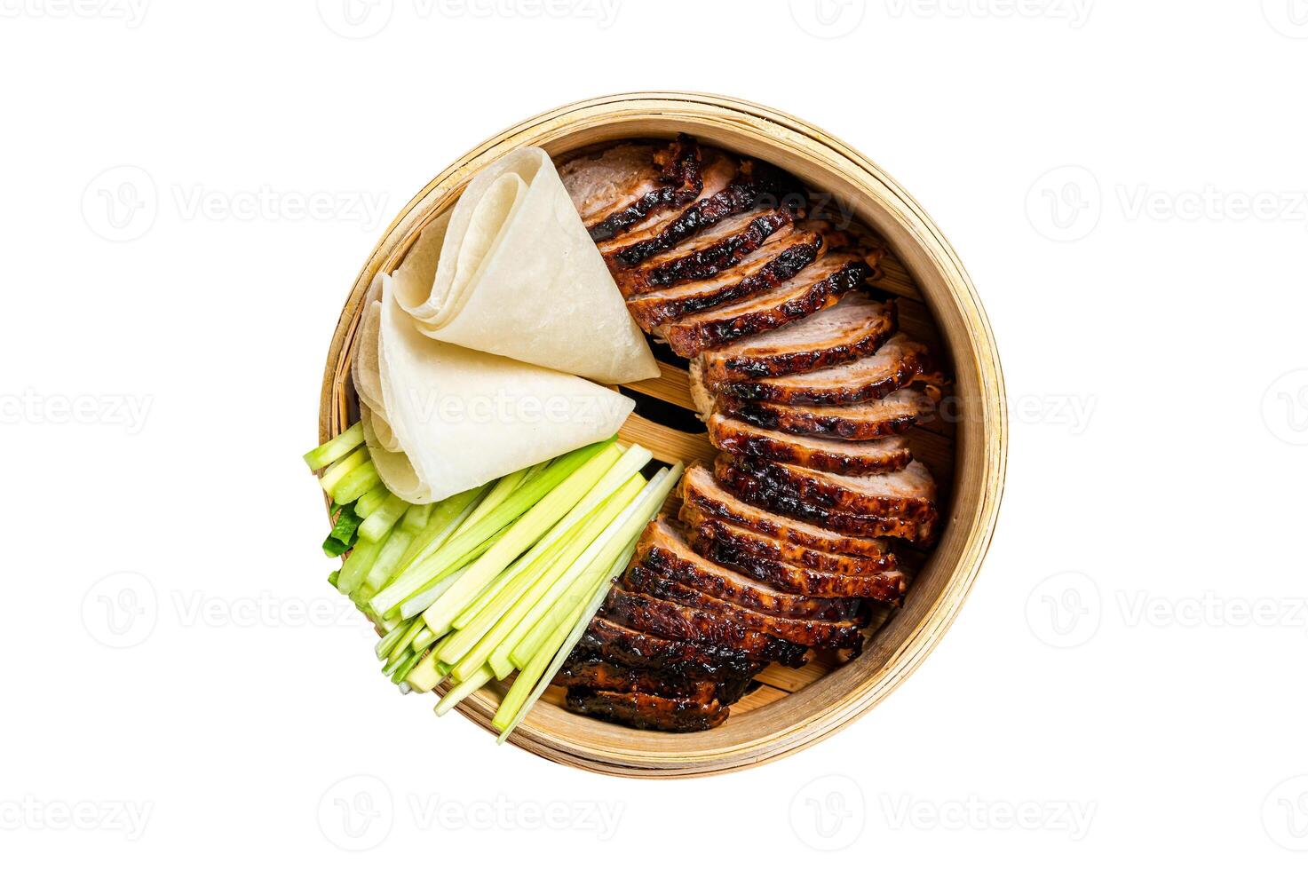Peking Duck in bamboo steamer served with cucumber, green onion, and wheaten chinese pancakes. Isolated on white background. photo