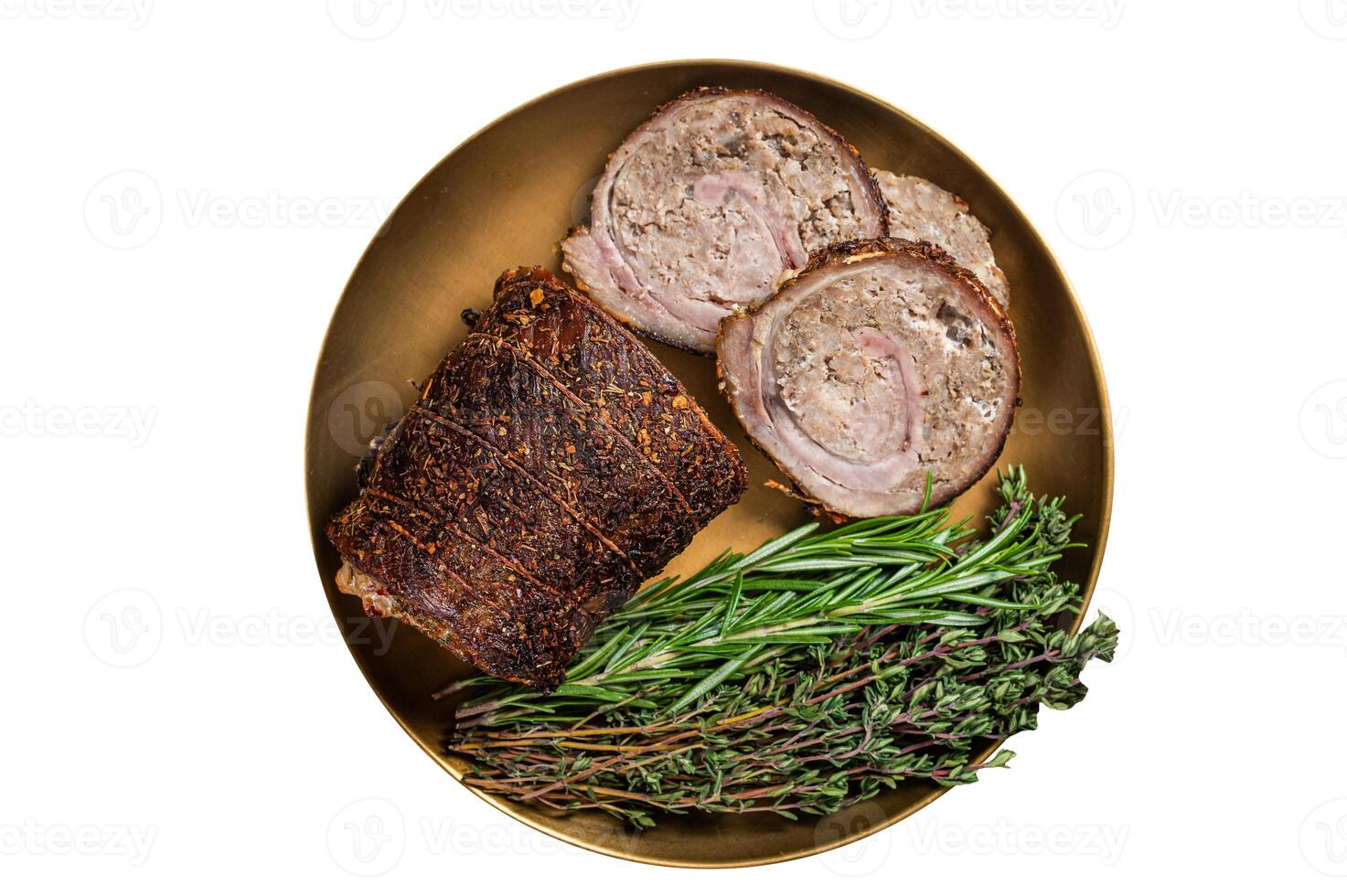Slices of roasted stuffed pork meat roulade on a plate with rosemary and thyme. Isolated on white background. photo