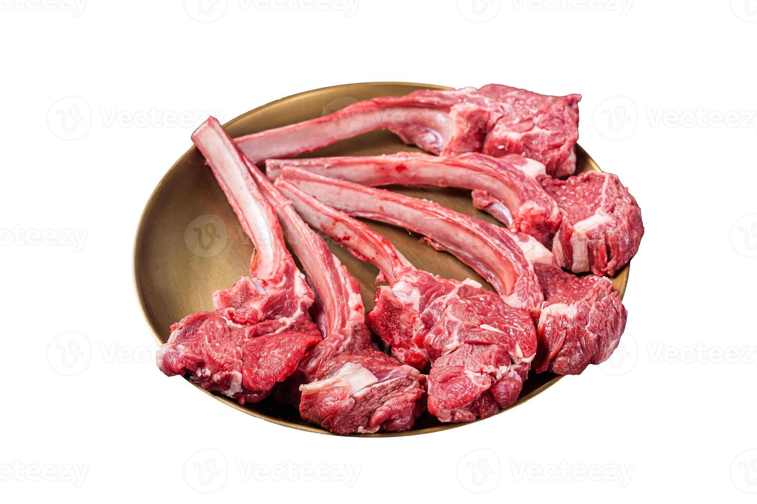 Lamb chop rib steak, raw mutton meat cutlet in golden plate. Isolated on white background. Top view. photo