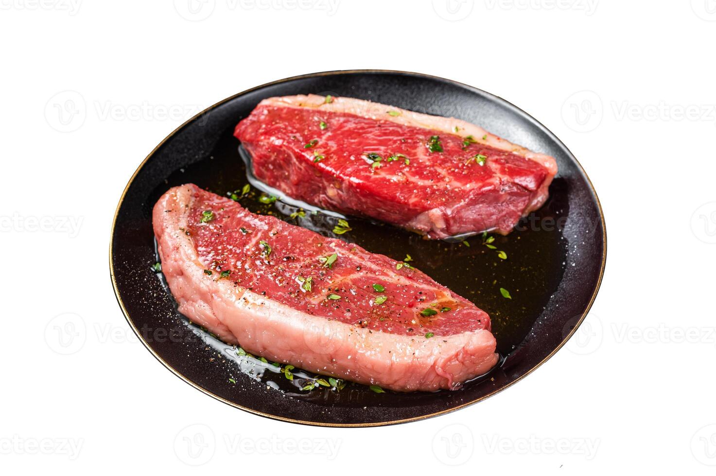 Raw marbled beef meat steak marinated with olive oil, thyme, salt and pepper. Isolated on white background. photo
