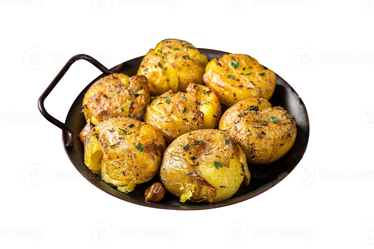 Broken potatoes baked in oil with herbs. Isolated on white background. Top view. photo