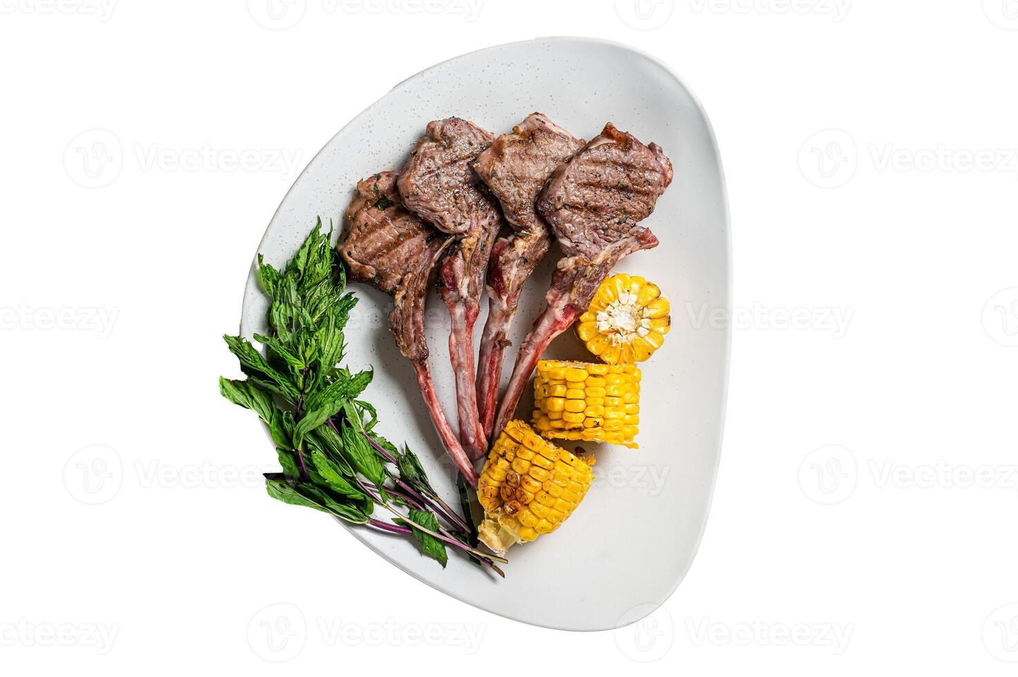 Grilled lamb chops steaks in a plate with corn and tomato. Isolated on white background. photo