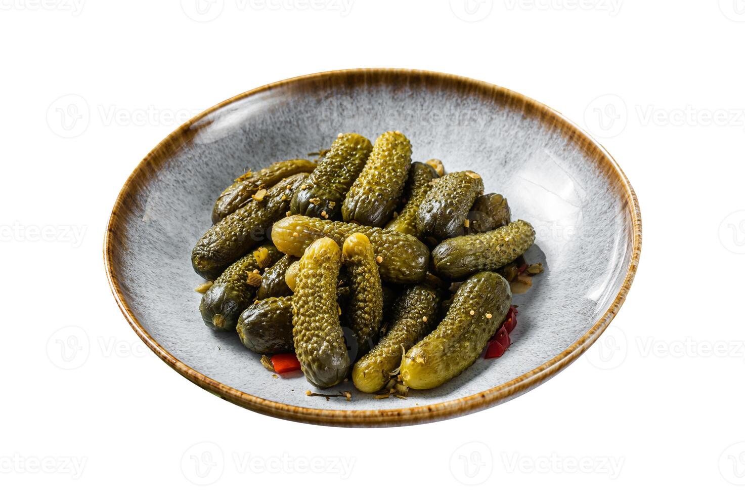 Plate with Pickled gherkins cucumbers on wooden board. Isolated on white background. Top view. photo