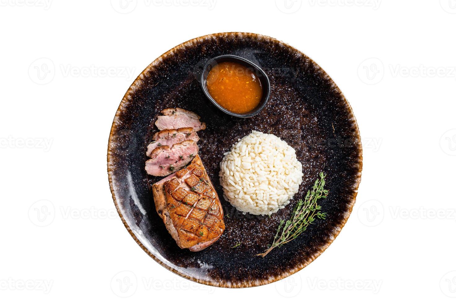 Roasted Duck breast steak, poultry fillet meat with sauce and rice. Isolated on white background. photo