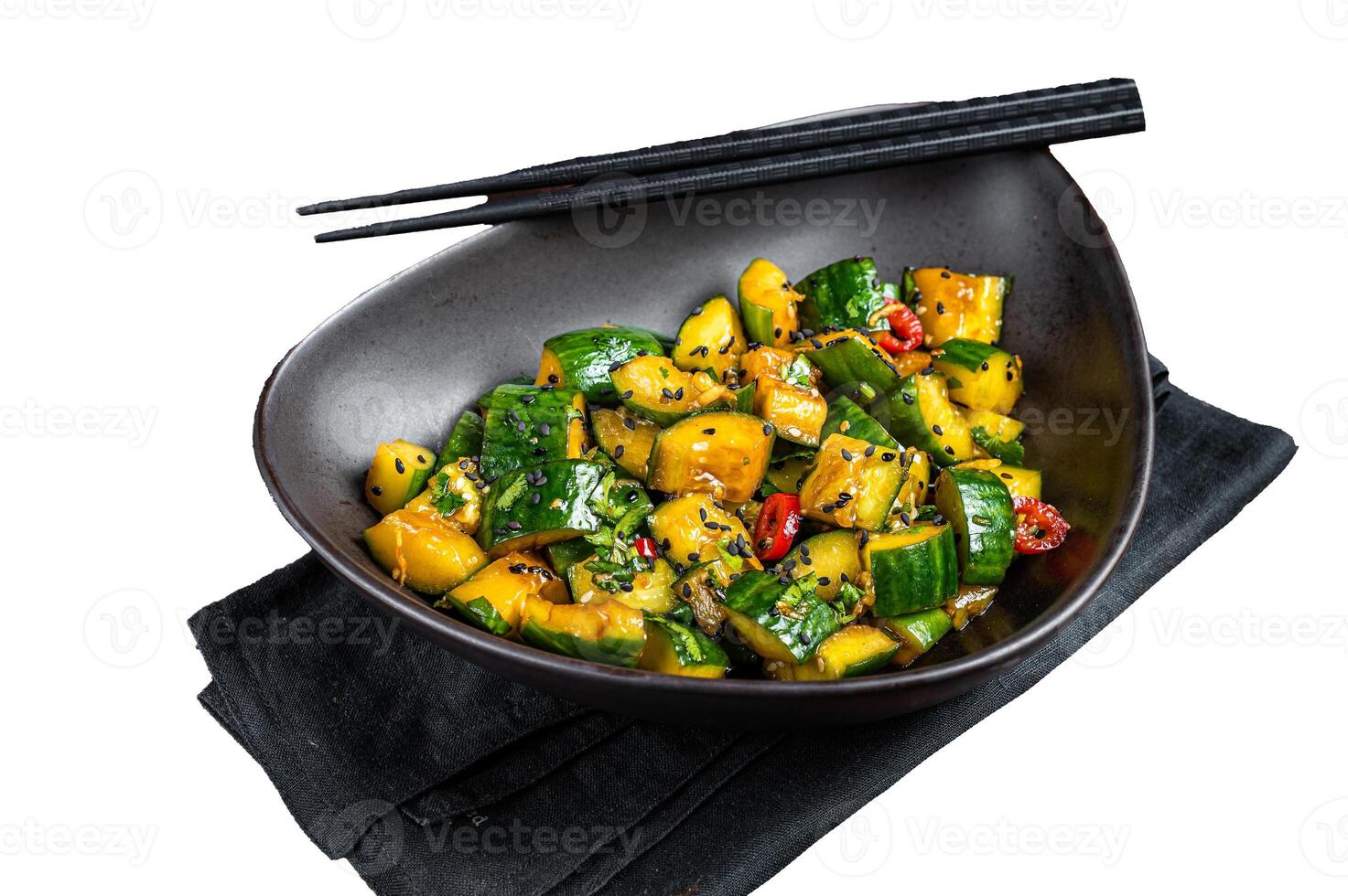 Chinese smashed cucumbers with herbs and sesame oil. Isolated, white background. photo