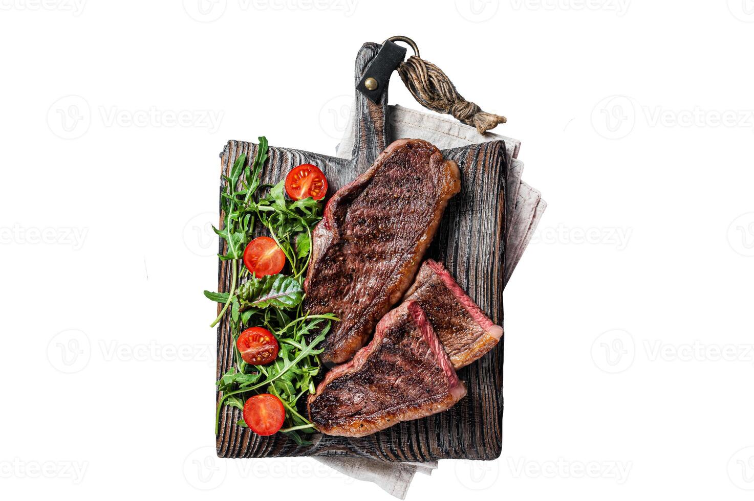 Roasted cap rump or Top sirloin beef meat steak on wooden board with salad. Isolated on white background. photo