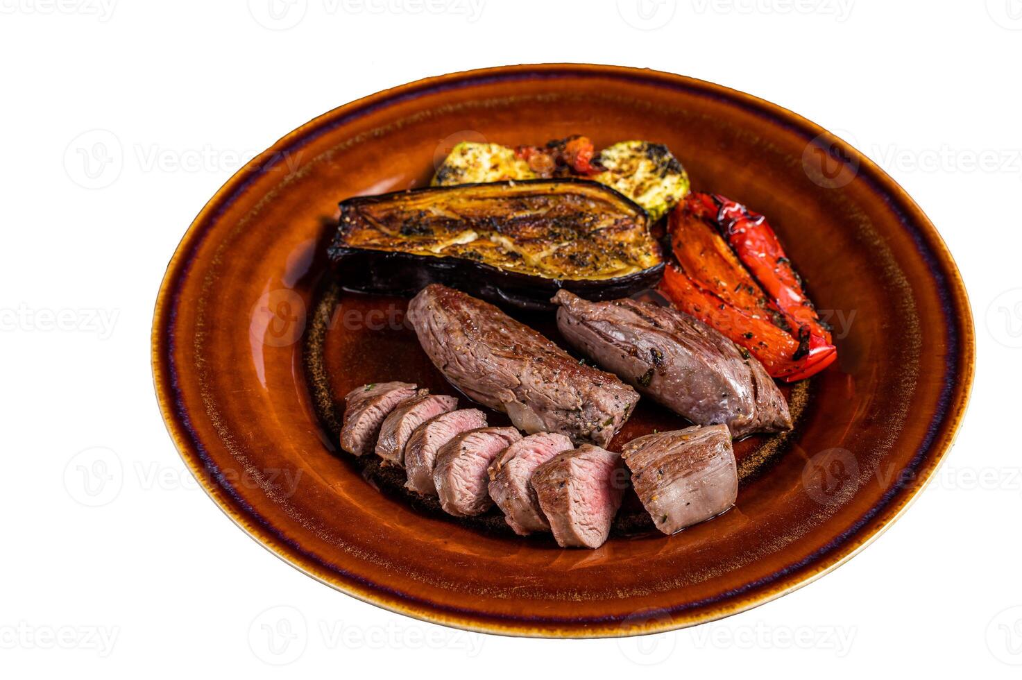 Grilled mutton tenderloin Fillet Meat, lamb sirloin on rustic plate with vegetables. Isolated on white background photo