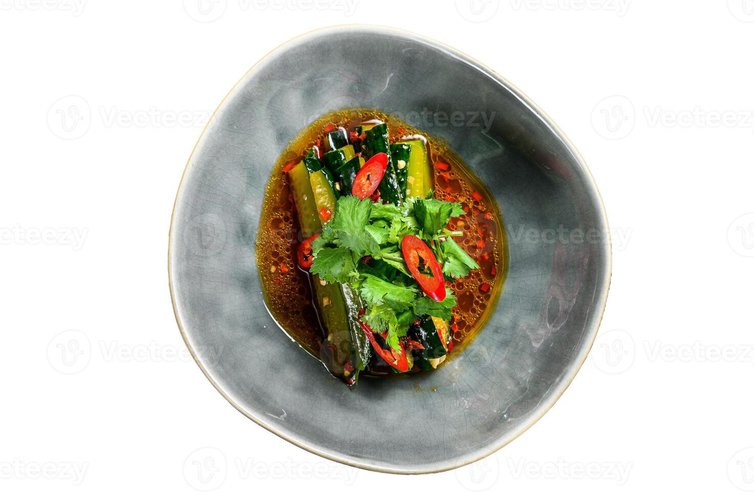 Chinese cucumber salad with chili pepper, garlic, soy sauce and sesame oil. Isolated on white background. photo