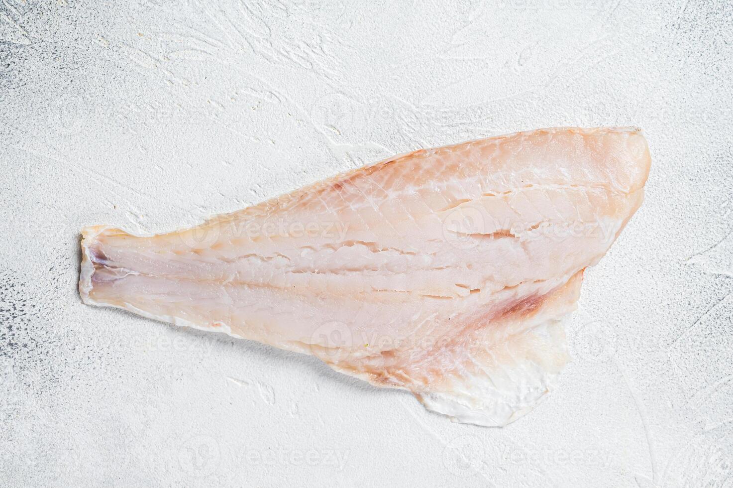 Raw red perch fillet, redfish fish meat. White background. Top view. Copy space photo