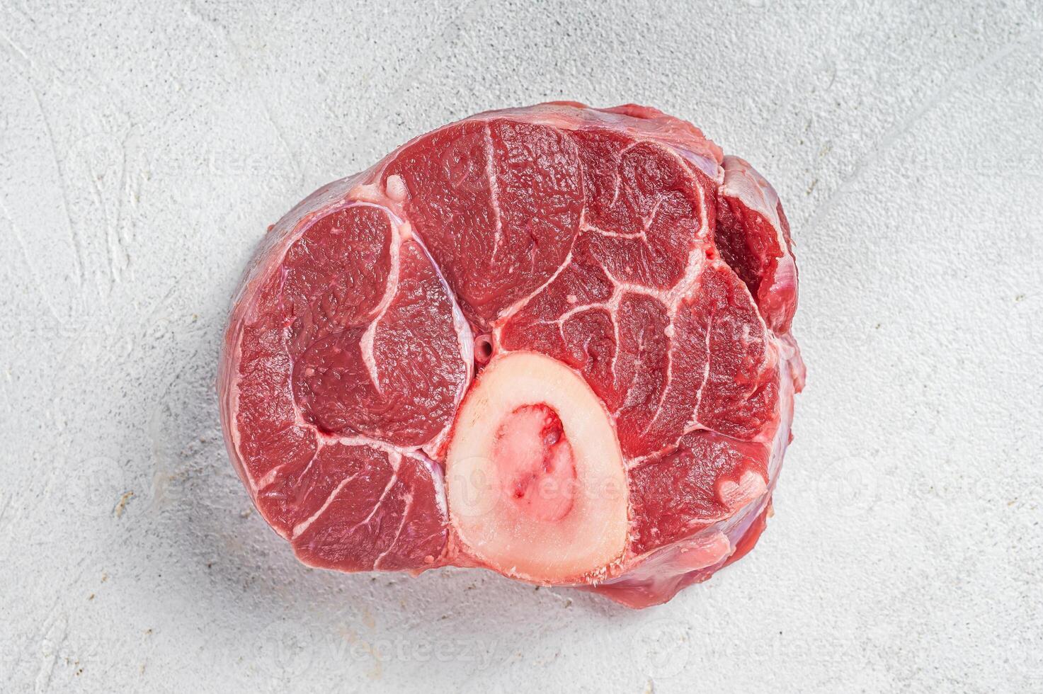 Raw Osso buco Veal shank steak, meat Ossobuco. White background. Top view. Copy space photo