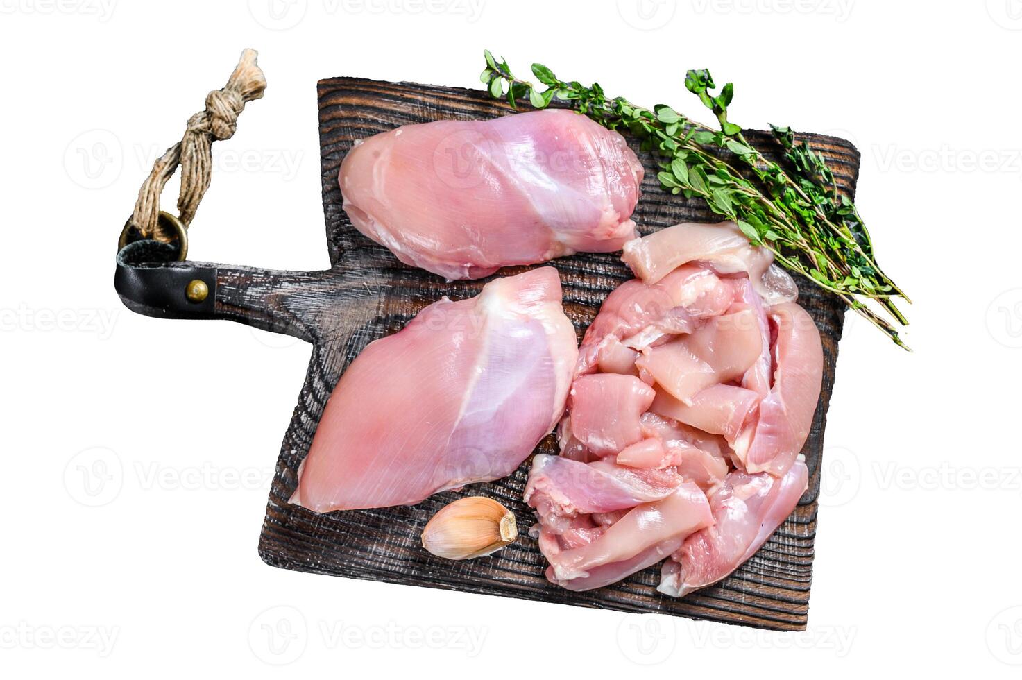 Sliced Raw Chicken thigh fillet on a wooden cutting board. Isolated on white background, top view. photo