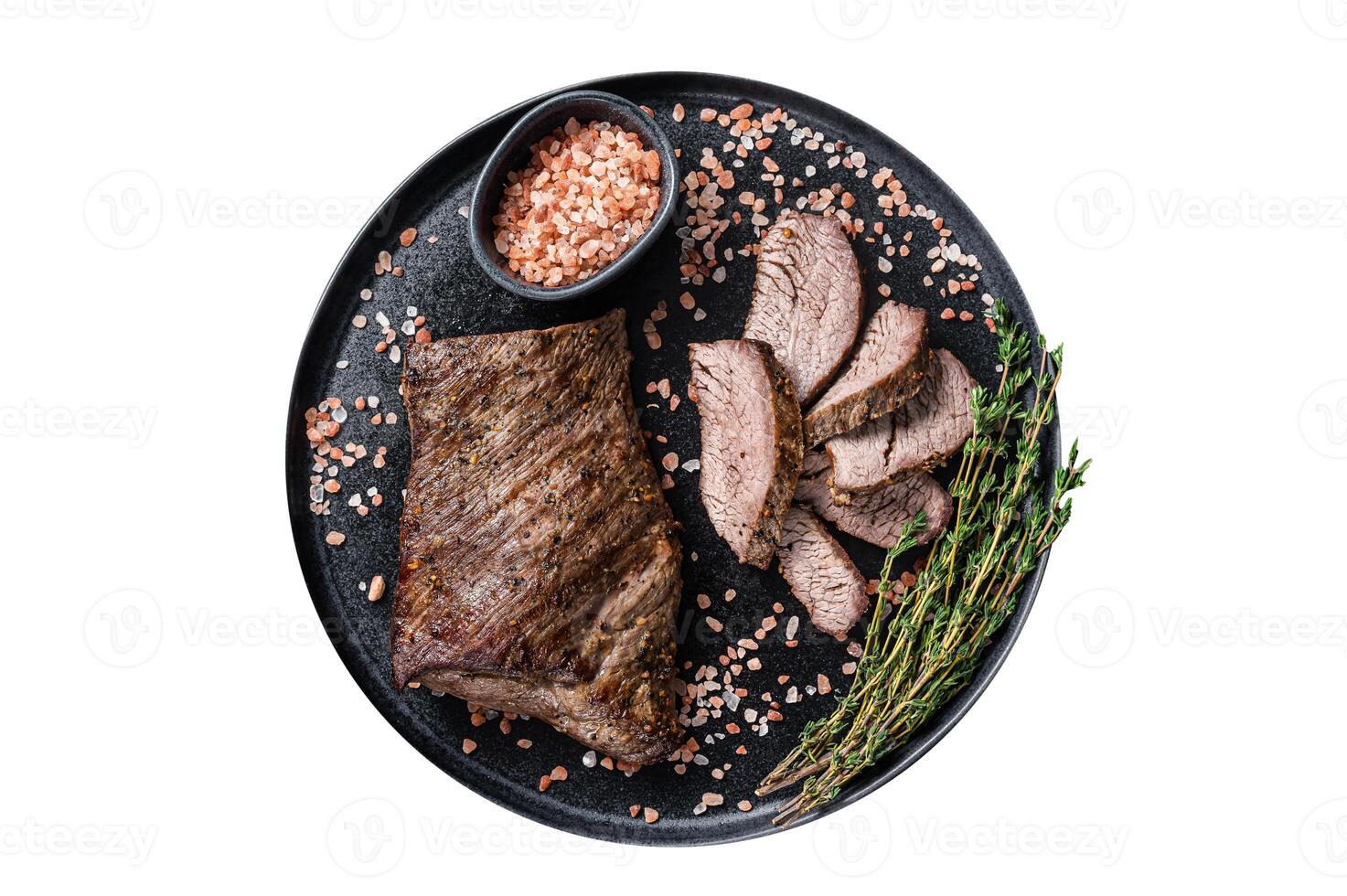 Barbecue dry aged wagyu Tri Tip beef steak on a plate with pink salt. Isolated on white background. photo