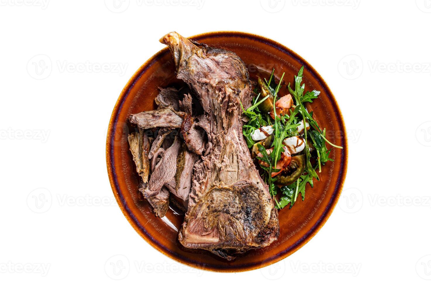 Grilled goat or lamb mutton shoulder meat in a rustic plate with salad. Isolated on white background. photo