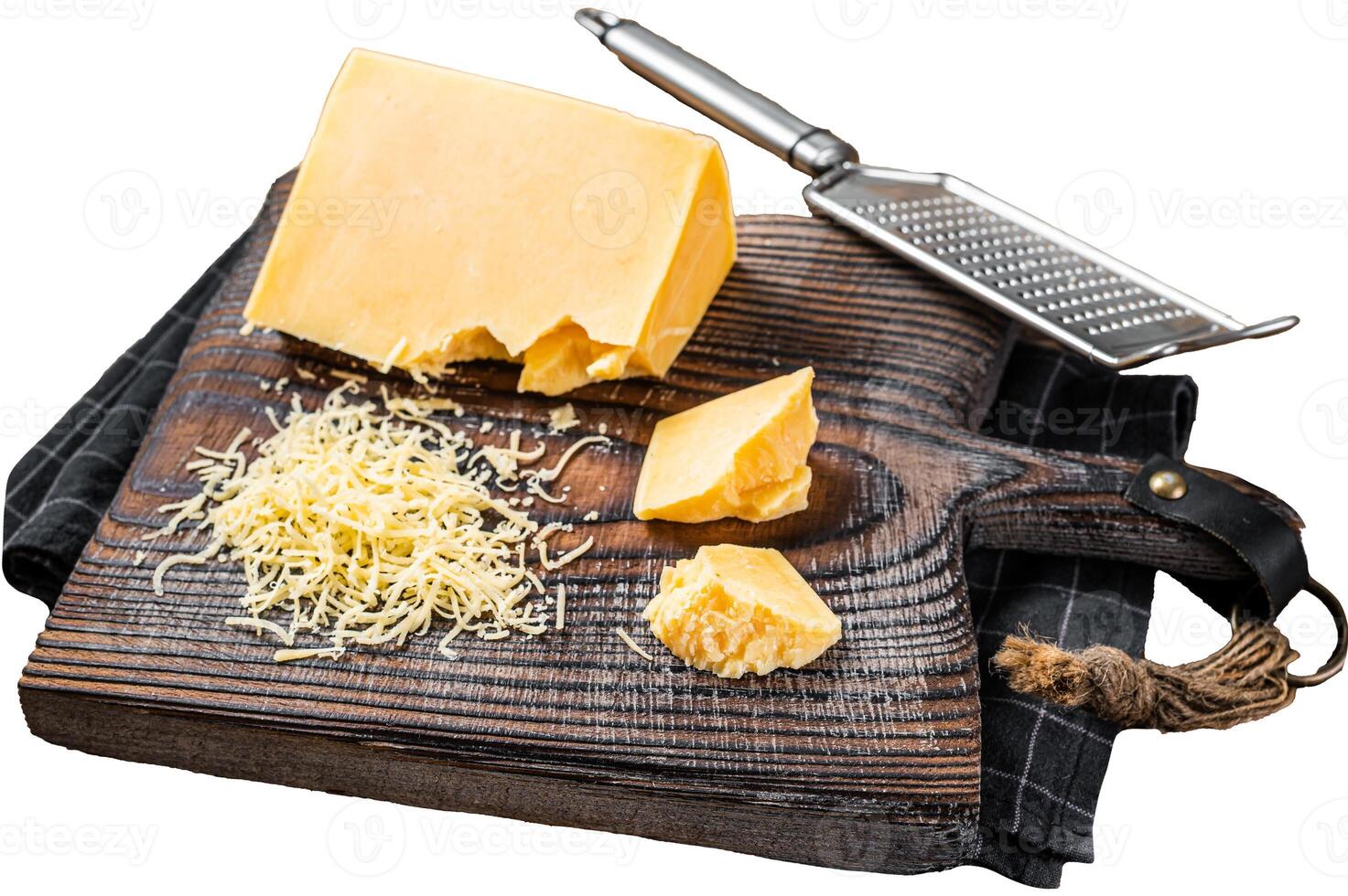 Grated cheddar cheese piece on a wooden board. Isolated on white background, top view. photo