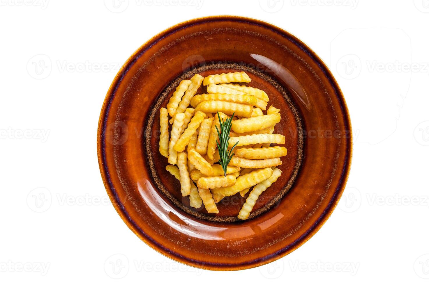 Fried Crinkle French fries potatoes or chips in a rustic plate. Isolated on white background. photo