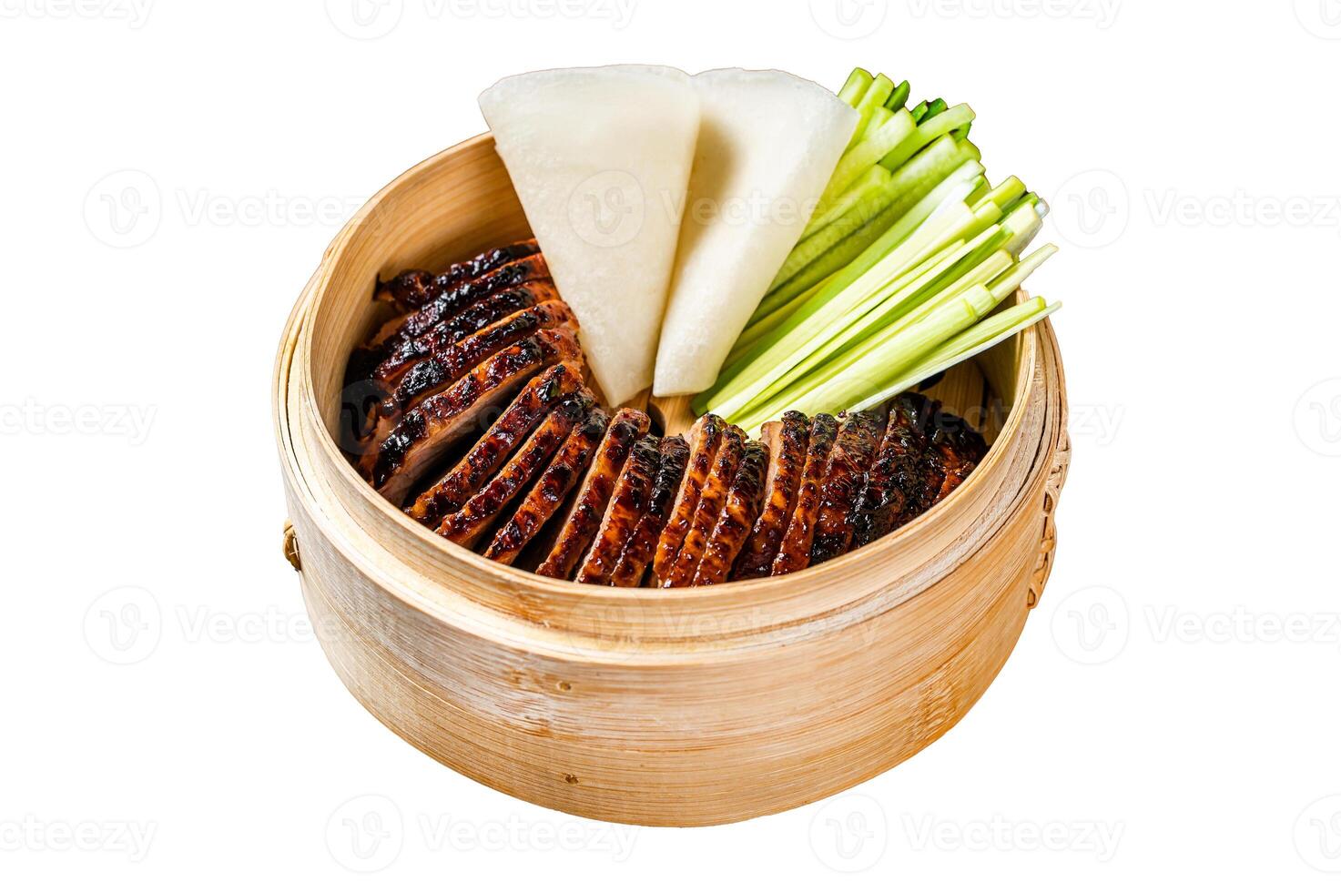 Peking Duck in bamboo steamer served with cucumber, green onion, and wheaten chinese pancakes. Isolated, white background. photo